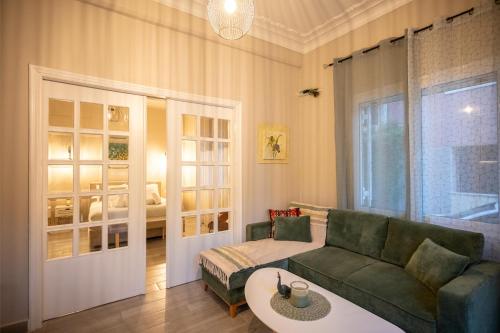 a living room with a couch and a table at Peacock's Apartments in Piraeus
