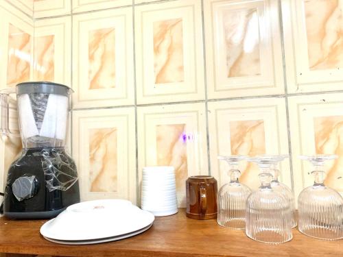 a counter with a blender and some bottles on it at Luxury apartment Yaoundé in Yaoundé
