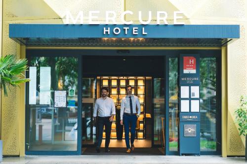two men standing in the doorway of a hotel at Mercure Metz Centre in Metz