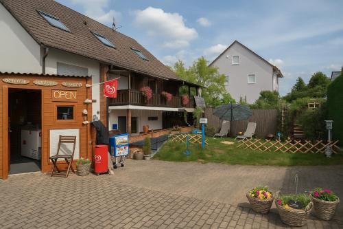 a building with an open sign in front of it at SeeOase in Muhr am See inkl Frühstück in Muhr amSee