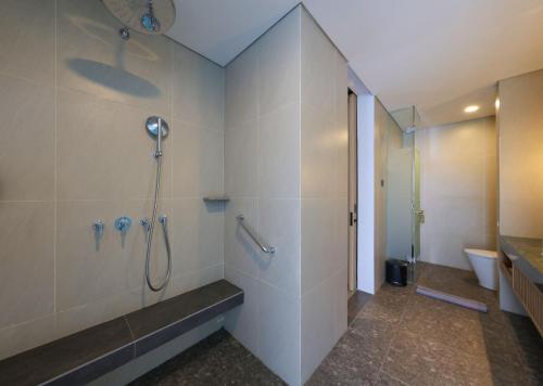 a bathroom with a shower and a toilet at Hotel Santika Premiere Garut in Garut