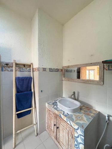 a bathroom with a sink and a mirror at Mango 5 Hotel in Amed