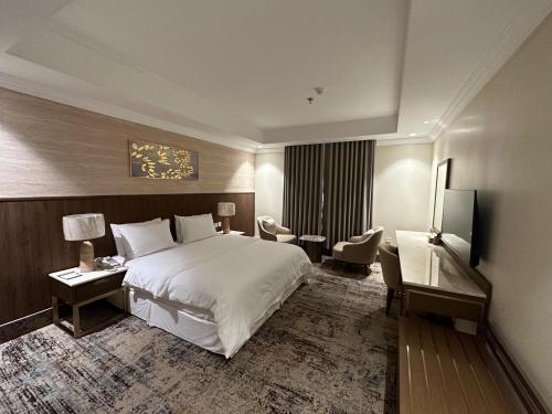 a hotel room with a bed and a desk at شقق جوين للوحدات السكنية المفروشة- اقتصادي in Jeddah