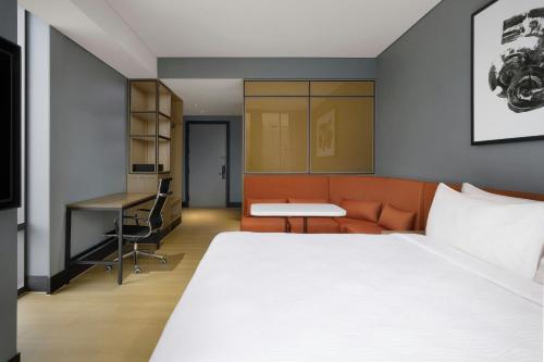 a hotel room with a bed and a desk at GRAVITY JOSUN Seoul Pangyo, Autograph Collection in Seongnam