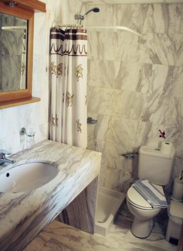 a bathroom with a sink and a toilet at Mythos Beach Hotel Apartments in Maleme