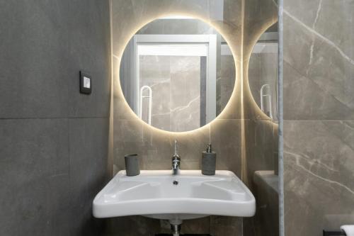 a bathroom with a sink and a mirror at Nova Suite in Catania