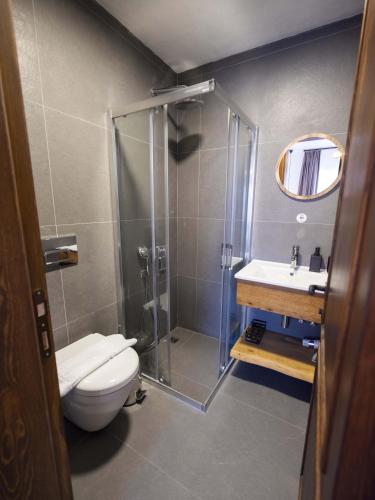 a bathroom with a shower and a toilet and a sink at Casa Alegre Alaçatı in Alacati