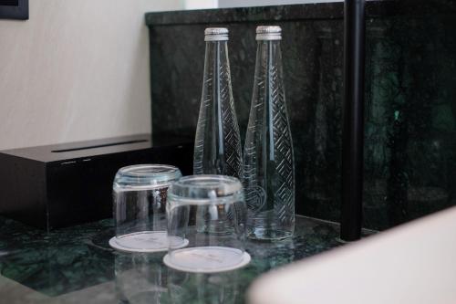 three glass bottles sitting on top of a table at Hotel Santika Premiere Garut in Garut
