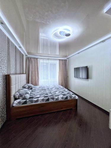 a bedroom with a large bed in a room at Krasnyi Mist in Chernihiv