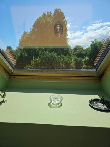 a window in a room with a table and a plate at Chambre Gauguin - B no B les closeries du Golfe in Theix
