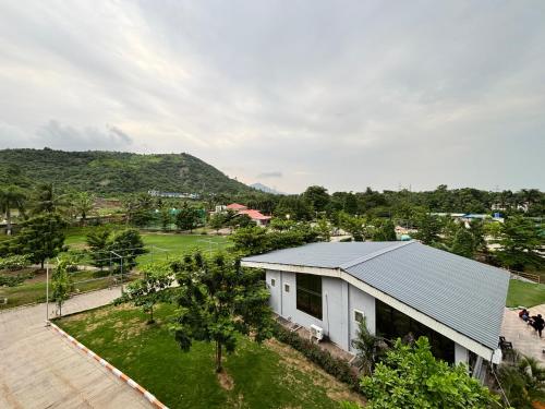 an aerial view of a white house with a yard at HillRock Resort & Villas, Neral-Karjat in Karjat
