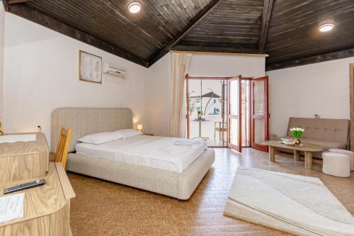 a bedroom with a bed and a living room at FKK Ada Bojana in Ulcinj