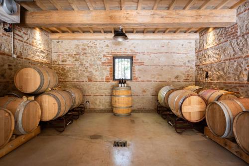 a room with a bunch of wine barrels in it at Grand Hotel Du Golfe - Spa & Restaurant in Collioure