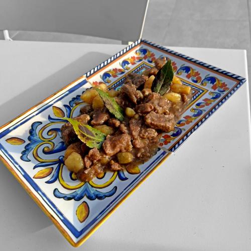 a plate of food with meat and vegetables on a table at Agriturismo Fattoria di Monticello in San Venanzo