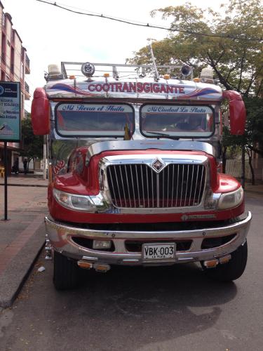 a red fire truck parked on a city street at Hotel Casa Pablo in Neiva