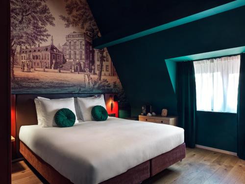a bedroom with a large bed with a blue wall at The Ald Hotel in The Hague