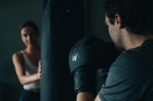 a woman is looking at a man in a boxing glove at MANNI das Hotel in Mayrhofen