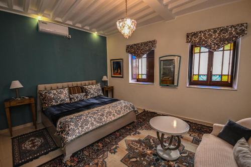 a bedroom with a bed and a couch at Palais Harran in Kairouan