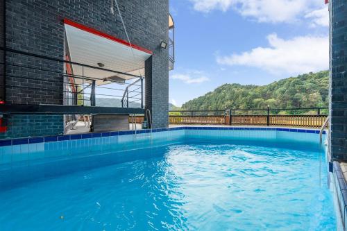 a swimming pool in the middle of a building at Gapyeong River52 Road Pension in Gapyeong
