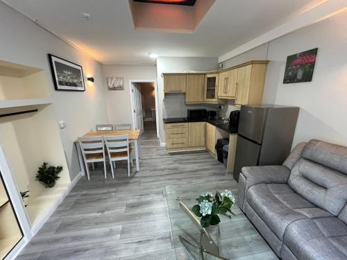 a living room and kitchen with a couch and a table at Shamrock Inn in Cork