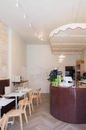 a restaurant with tables and chairs and a counter at Hotel M Soleil - Montpellier Centre Saint Roch in Montpellier