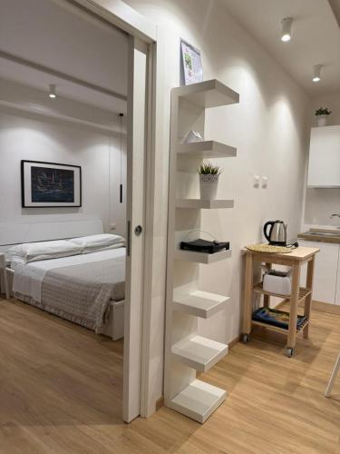a bedroom with a bed and a desk next to a book shelf at Mood's Home in Avola