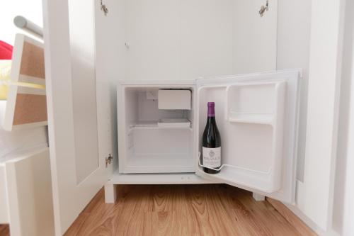 a white refrigerator with a bottle of wine in it at Rooms Butković in Zagreb