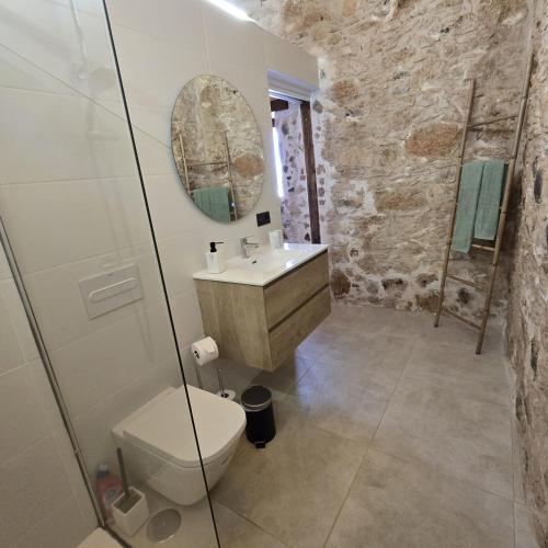 a bathroom with a toilet and a sink at La Montañeta - Tefia Suites in Tefía
