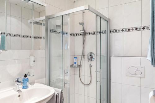 a bathroom with a shower and a sink at Gasthaus Mamoosen in Penning