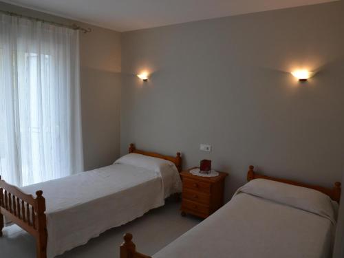 a bedroom with two beds and a window at Casa con Piscina y Cerca de la Playa en L'Estartit - ES-323-65 in L'Estartit