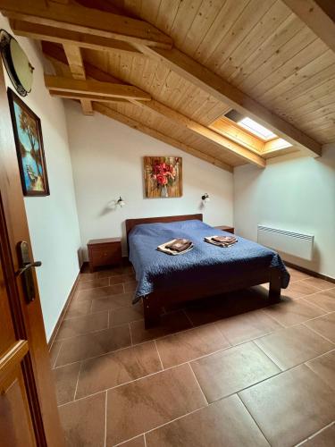 a bedroom with a bed with a blue comforter at Csigevár Birtok 2 in Balatonendréd