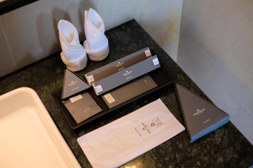 a pair of shoes and a box of heels on a counter at Hotel Santika Premiere Garut in Garut