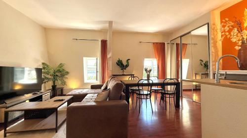 a living room with a couch and a table at Duplex - Air-conditioned - City Center in Villefranche-sur-Saône