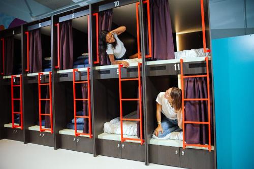 a group of bunk beds with people in them at Stayokay Hostel Eindhoven in Eindhoven