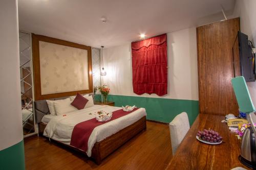 a bedroom with a bed with a red curtain at NT Elysian hotel in Hanoi