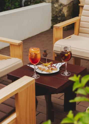 a table with a plate of food and two wine glasses at Wecamp San Sebastián in San Sebastián