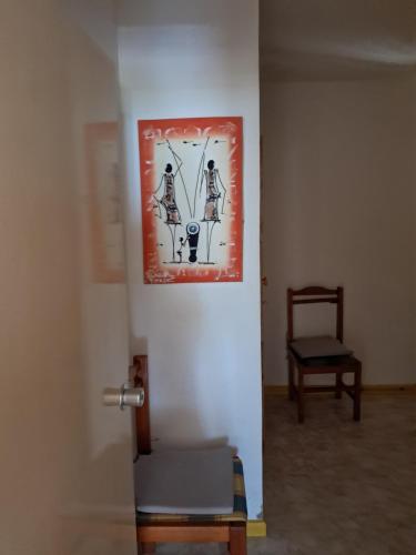 a room with a painting on the wall and a chair at Vivenda Mia in Beirona
