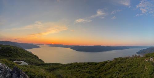 a view of a body of water at sunset at Brekkestranda Fjordhotel in Brekke