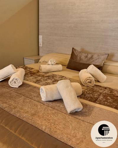 a group of towels sitting on a bed at Apartamentos Basílica Santa Eulalia con Parking Gratis in Mérida