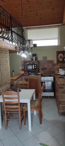 a kitchen with a table and chairs and a staircase at Lavendel Apartman in Harkány