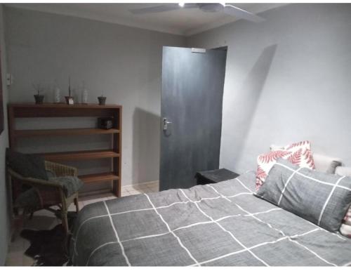 a bedroom with a large bed and a closet at The Chardonnay Inn in Centurion