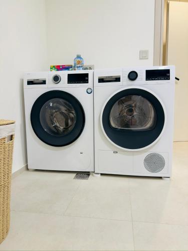 two washing machines sitting next to each other in a room at Seanatra Luxury Villas in Ferma