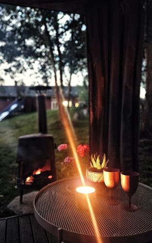 a table with two candles and a fire place at Orrefors Vandrarhem in Nybro