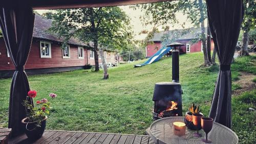 a outdoor table with a fireplace in a yard at Orrefors Vandrarhem in Nybro
