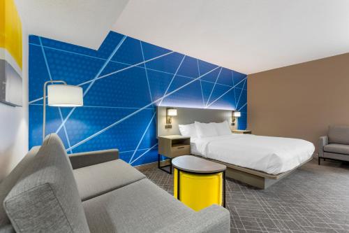 a hotel room with a bed and a couch at Comfort Inn Blythewood - North Columbia in Blythewood