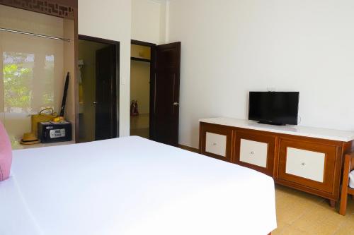 a bedroom with two beds and a tv on a dresser at Minera Hot Springs Binh Chau in Binh Chau