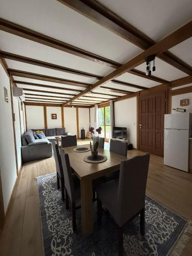a dining room with a table and chairs at Vikendica Čardak in Srebrenik