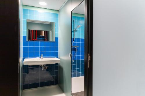 a bathroom with a sink and a mirror at Stayokay Hostel Eindhoven in Eindhoven