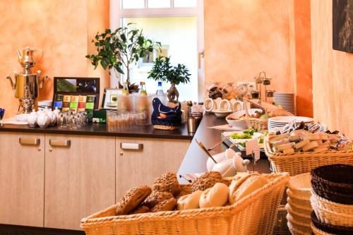 a kitchen with baskets of food on a counter at Hotel Wehlener Hof in Stadt Wehlen