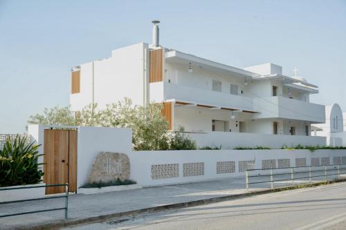 a white building on the side of a street at Akti Hotel Kavala in Paleo Tsifliki